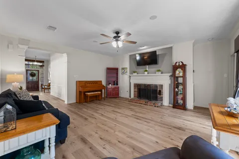a living room with furniture a fireplace and flat screen tv