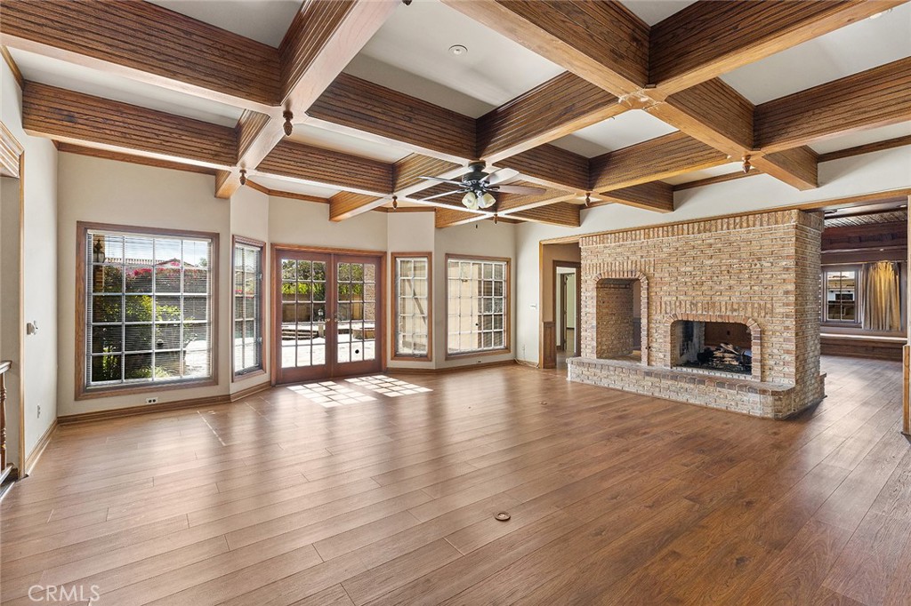 11550 183rd Street Artesia, CA 90701 - Photo 13 of 67 a view of an empty room with wooden floor and a fireplace