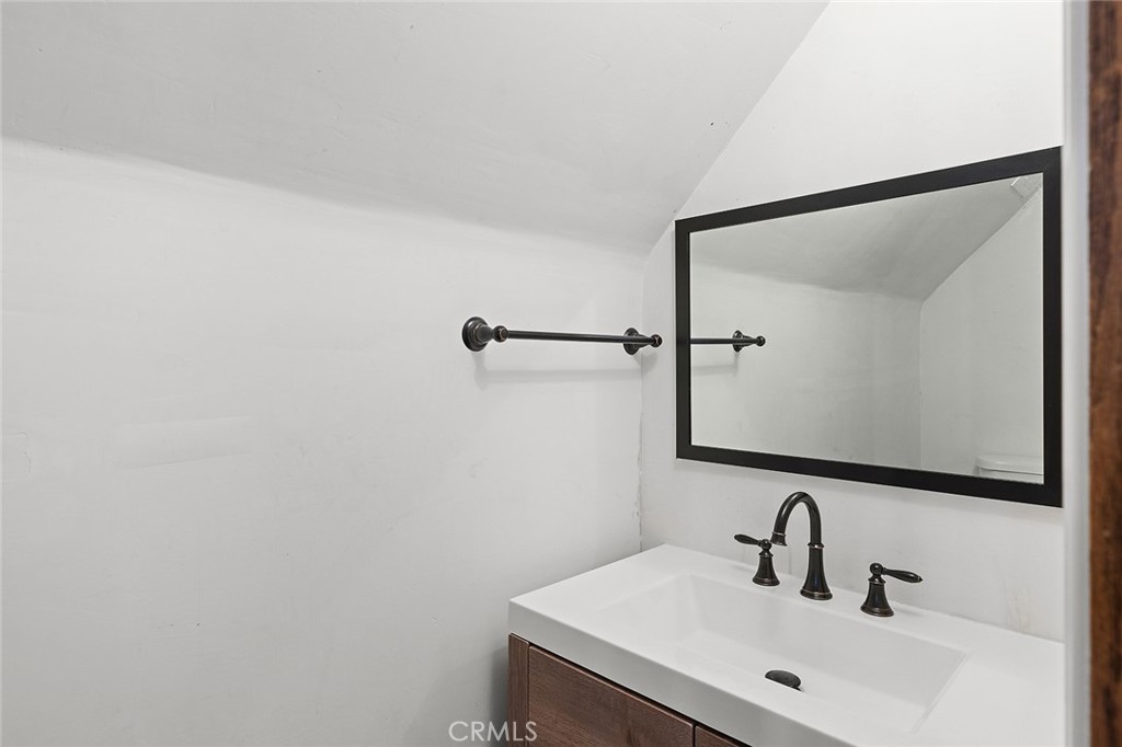 11550 183rd Street Artesia, CA 90701 - Photo 26 of 67 a bathroom with a sink and a mirror