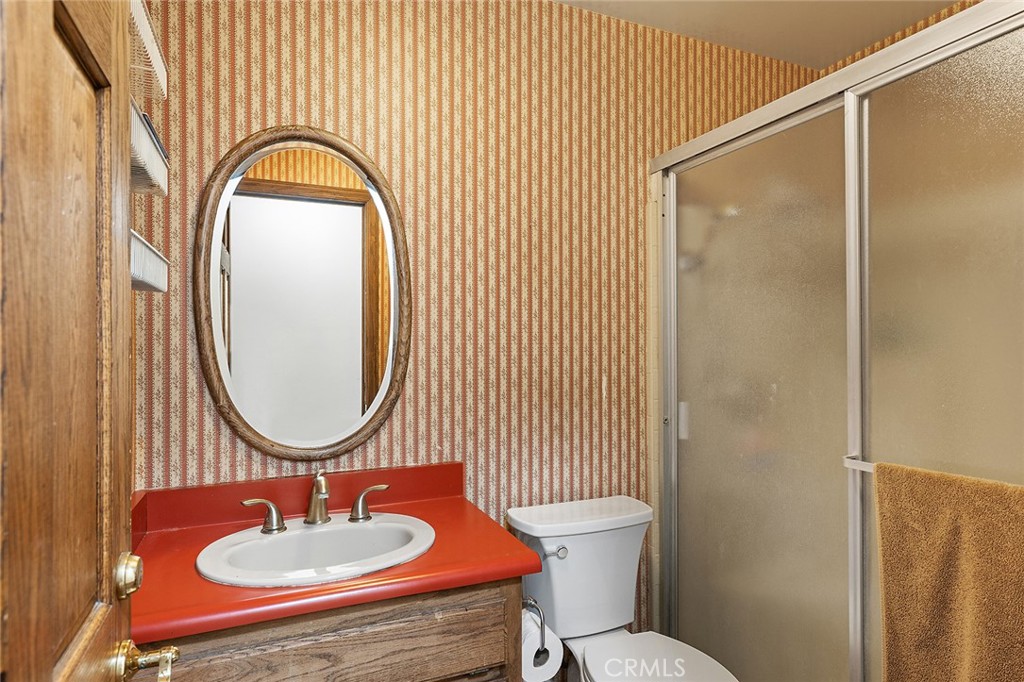 11550 183rd Street Artesia, CA 90701 - Photo 28 of 67 a bathroom with a sink toilet and a mirror