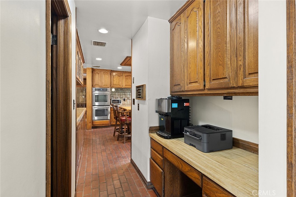 11550 183rd Street Artesia, CA 90701 - Photo 31 of 67 a kitchen with a refrigerator and a sink