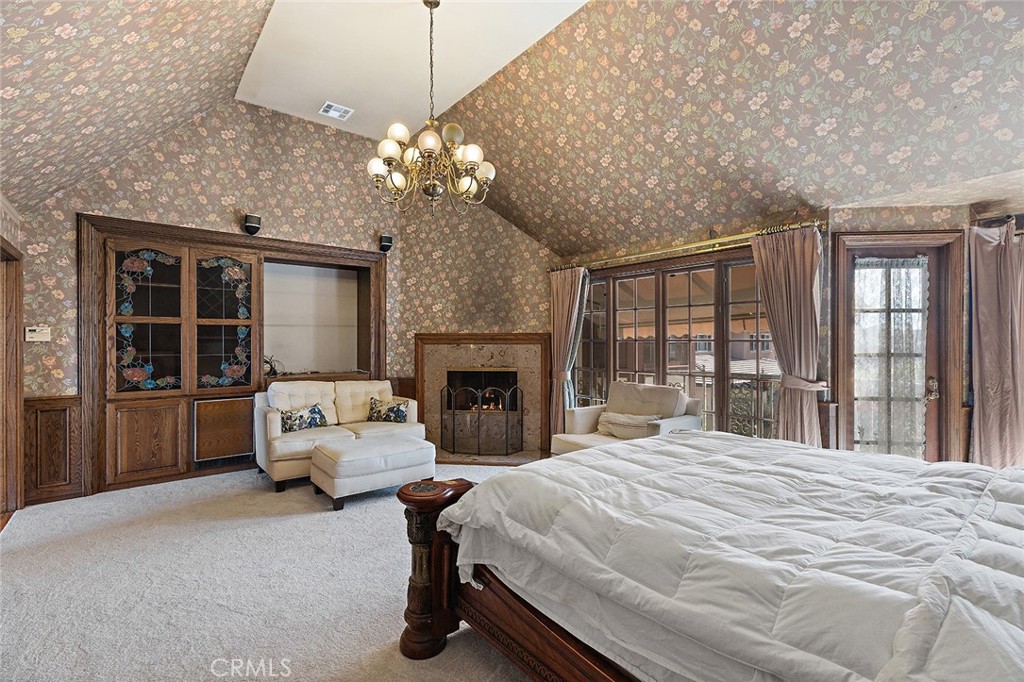 11550 183rd Street Artesia, CA 90701 - Photo 35 of 67 a spacious bedroom with a large bed and a chandelier