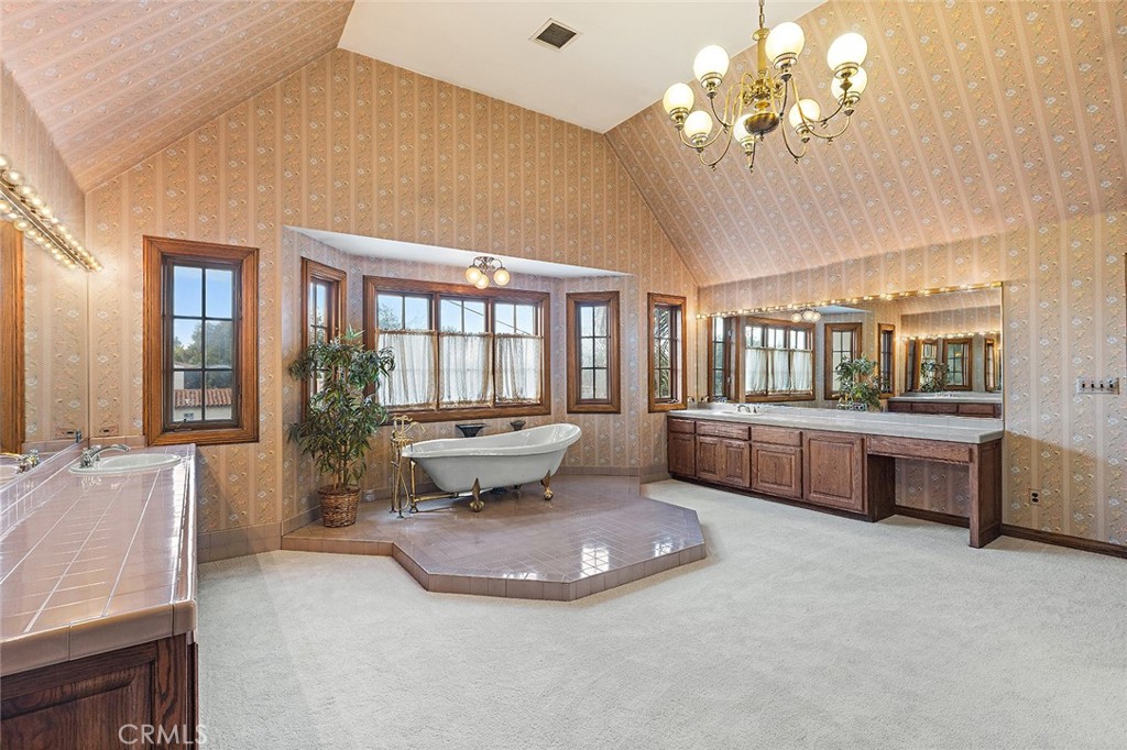 11550 183rd Street Artesia, CA 90701 - Photo 36 of 67 a living room with furniture and a chandelier