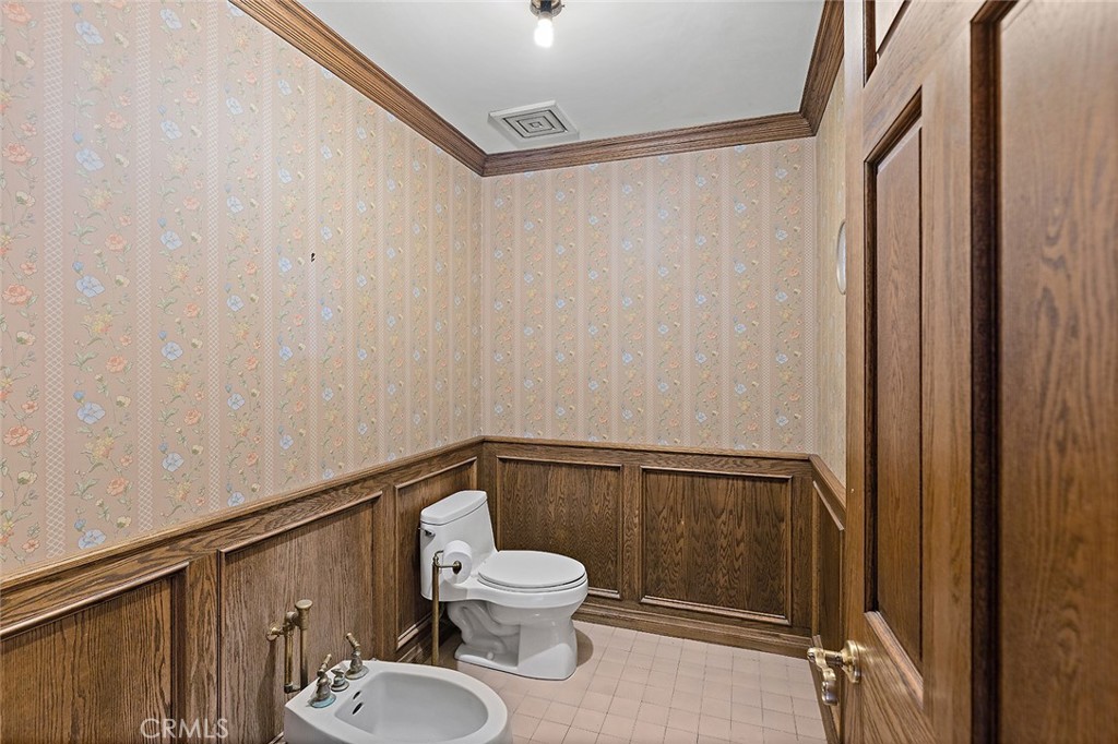 11550 183rd Street Artesia, CA 90701 - Photo 38 of 67 a bathroom with a toilet a sink and shower