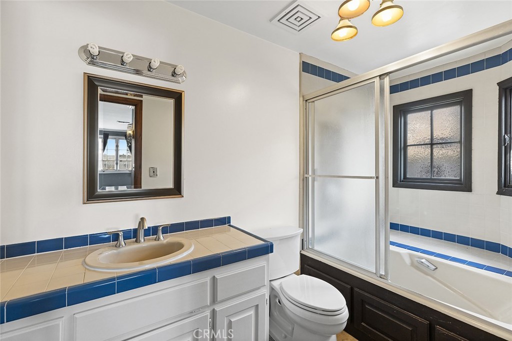 11550 183rd Street Artesia, CA 90701 - Photo 47 of 67 a bathroom with a toilet sink and mirror