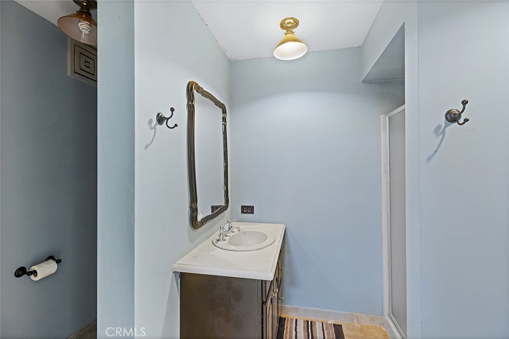 11550 183rd Street Artesia, CA 90701 - Photo 52 of 67 a bathroom with a sink and mirror