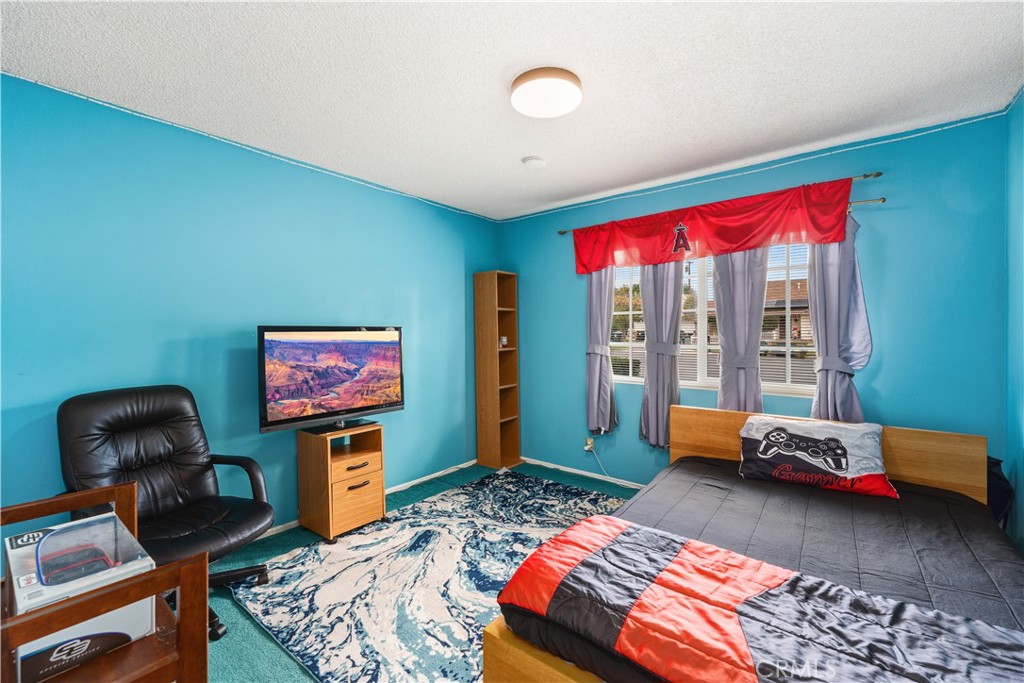 885 East Home Street Rialto, CA 92376 - Photo 13 of 26 a bedroom with furniture and a wooden floor