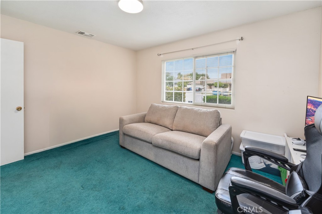 885 East Home Street Rialto, CA 92376 - Photo 16 of 26 a living room with furniture and a window