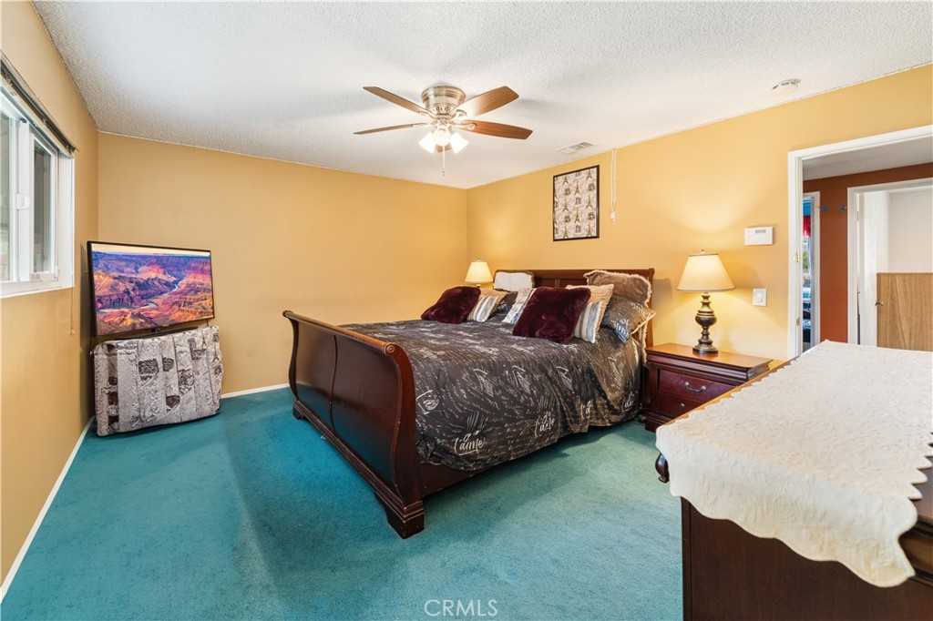 885 East Home Street Rialto, CA 92376 - Photo 18 of 26 a bedroom with bed and a chandelier