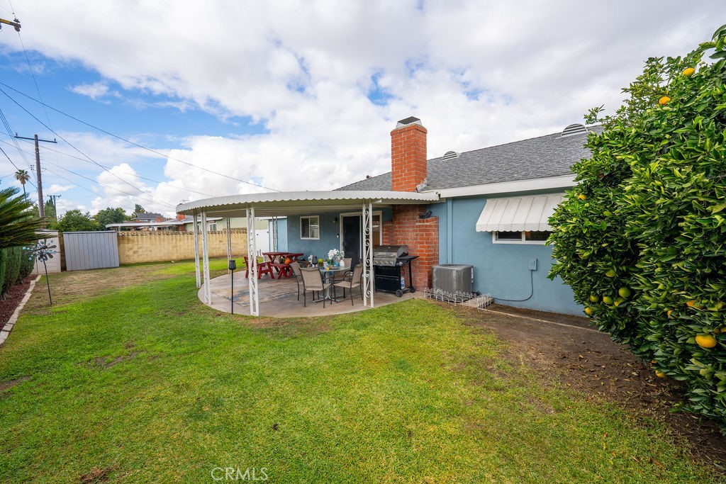 885 East Home Street Rialto, CA 92376 - Photo 21 of 26 a view of a house with a patio and a yard