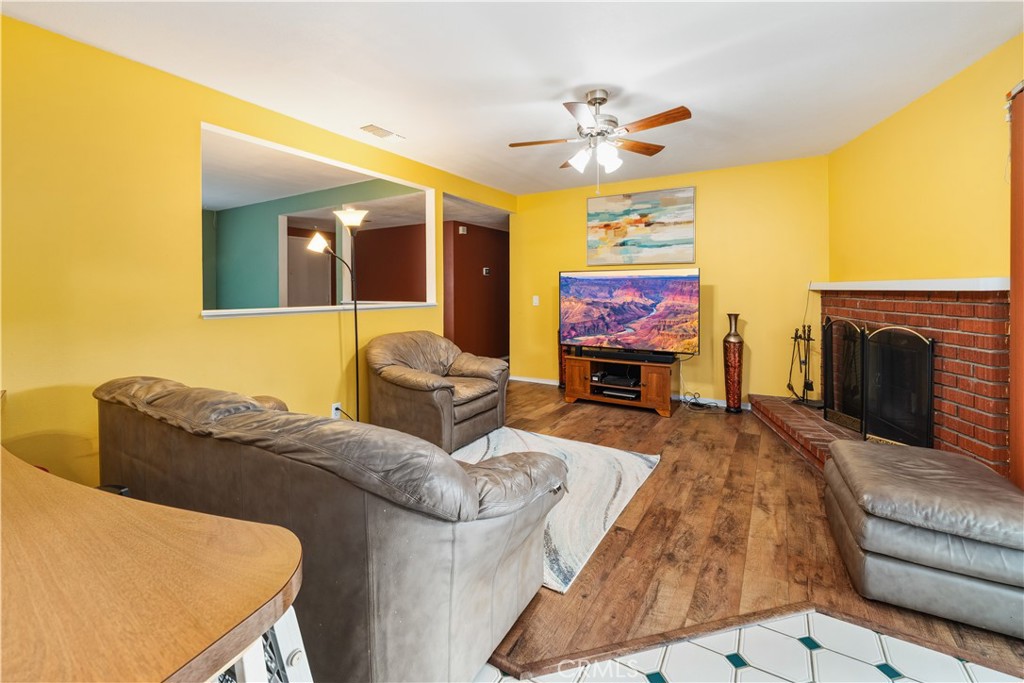 885 East Home Street Rialto, CA 92376 - Photo 8 of 26 a living room with furniture a fireplace and a flat screen tv