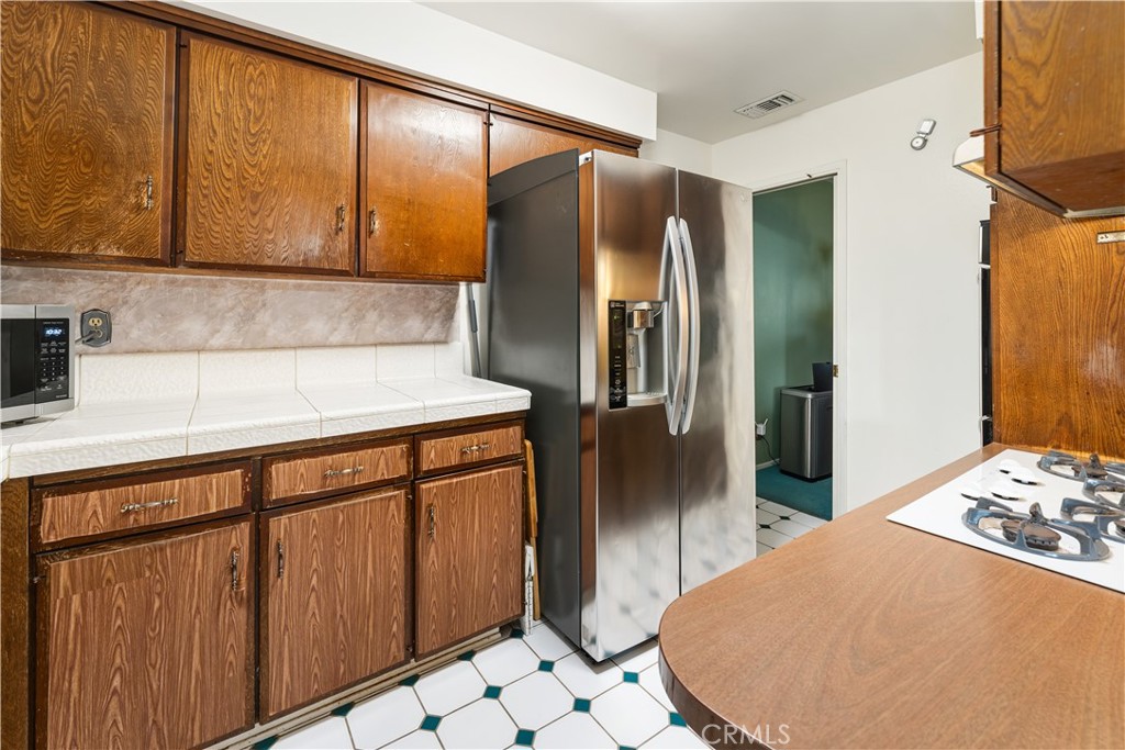 885 East Home Street Rialto, CA 92376 - Photo 10 of 26 a kitchen with stainless steel appliances a refrigerator and a stove