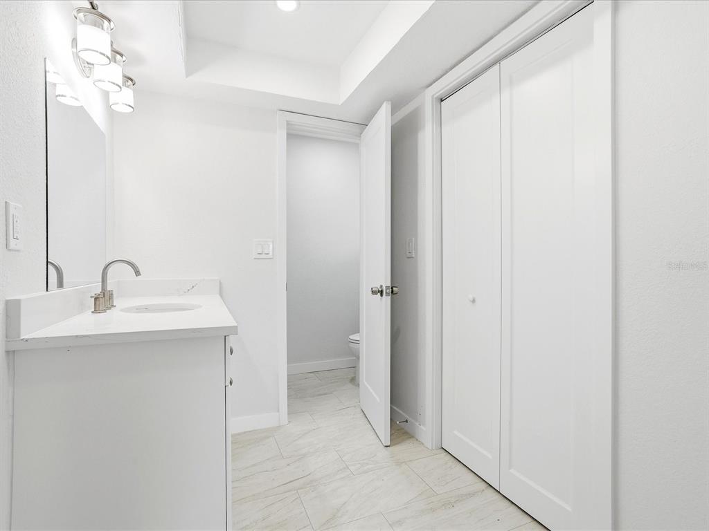 235 Pompano Terrace Punta Gorda, FL 33950 - Photo 14 of 30 a bathroom with a sink and mirror with toilet