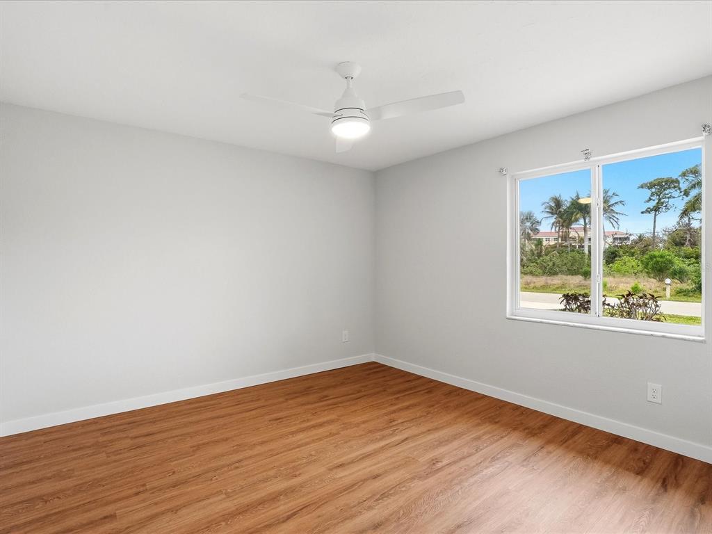 235 Pompano Terrace Punta Gorda, FL 33950 - Photo 17 of 30 a view of empty room with wooden floor and fan