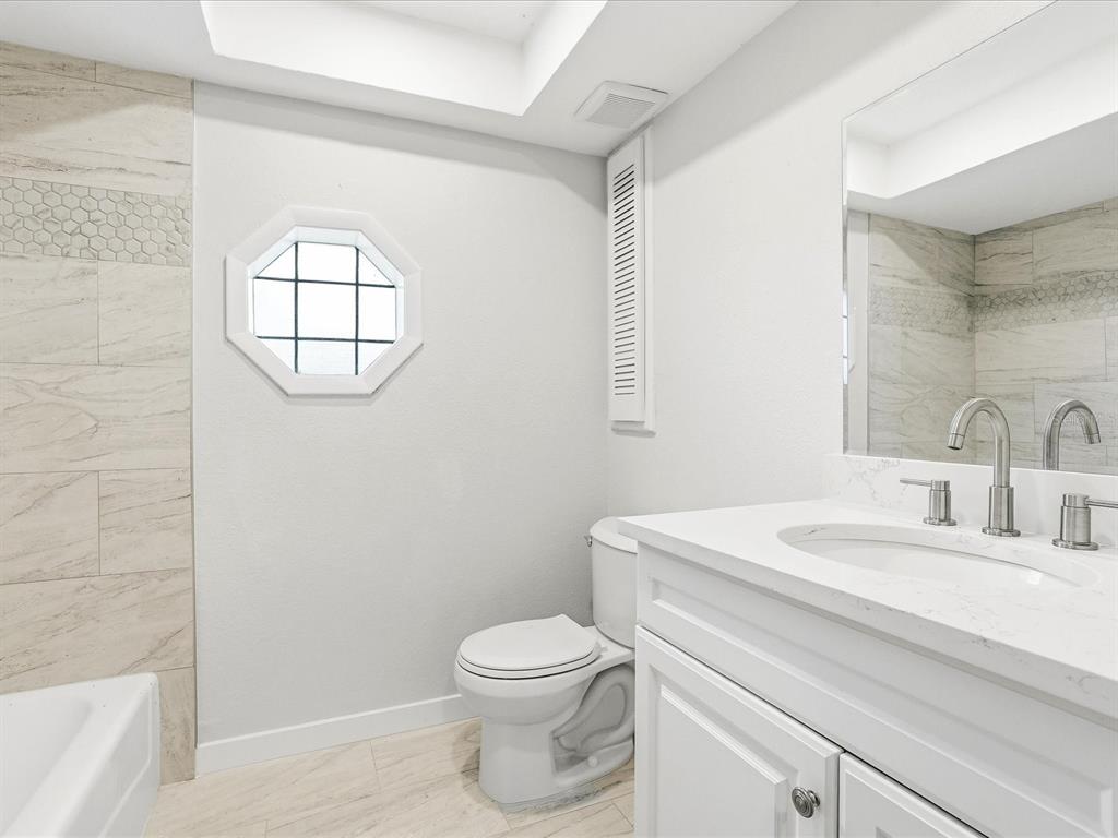 235 Pompano Terrace Punta Gorda, FL 33950 - Photo 18 of 30 a bathroom with a sink a toilet and a window