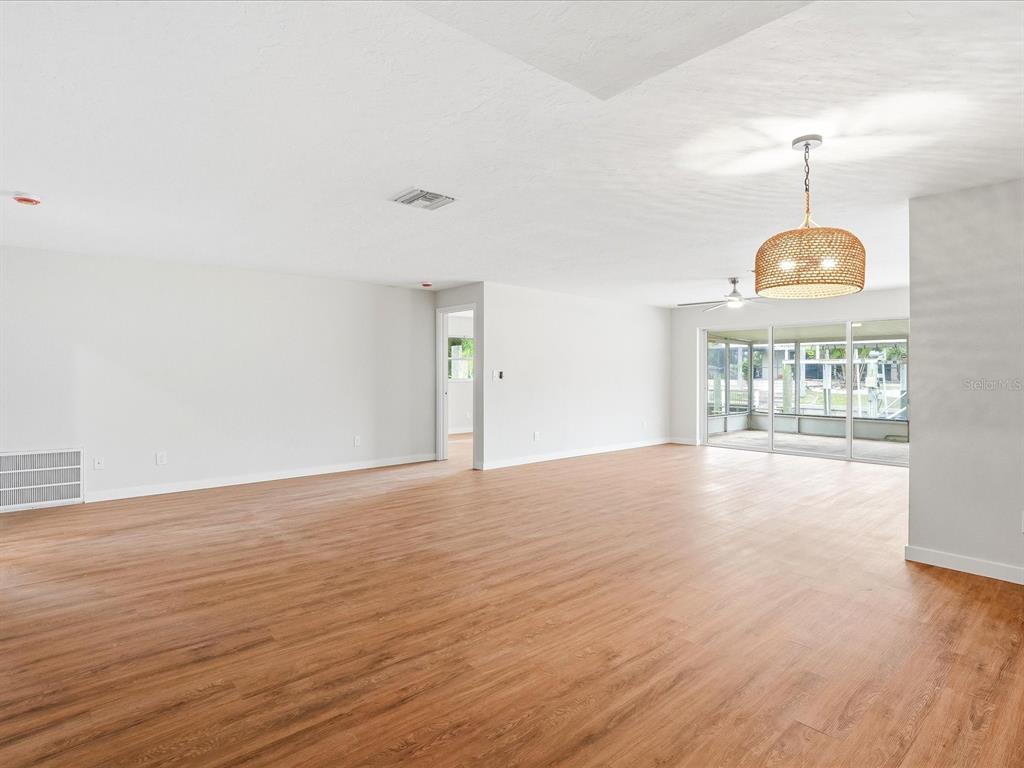 235 Pompano Terrace Punta Gorda, FL 33950 - Photo 3 of 30 a view of an empty room with wooden floor and a window