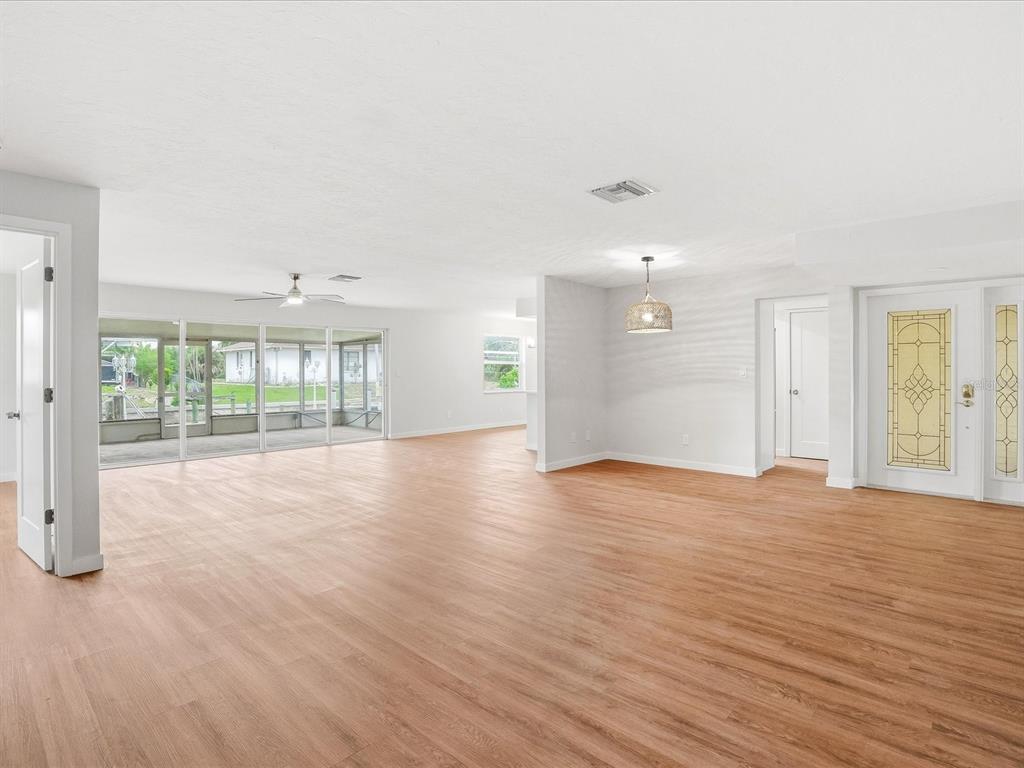 235 Pompano Terrace Punta Gorda, FL 33950 - Photo 4 of 30 a view of an empty room with wooden floor and a window