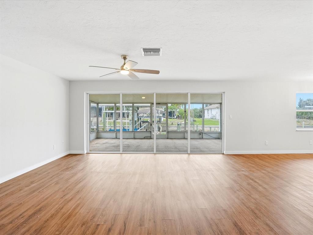 235 Pompano Terrace Punta Gorda, FL 33950 - Photo 5 of 30 wooden floor in an empty room with a window