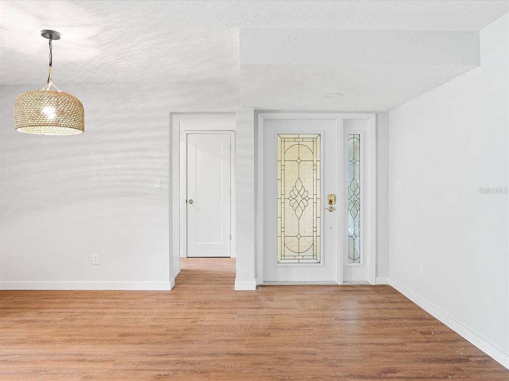 235 Pompano Terrace Punta Gorda, FL 33950 - Photo 8 of 30 a view of an empty room with wooden floor and window