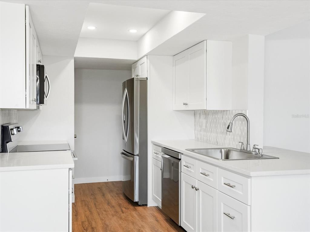 235 Pompano Terrace Punta Gorda, FL 33950 - Photo 10 of 30 a kitchen with a refrigerator sink and cabinets