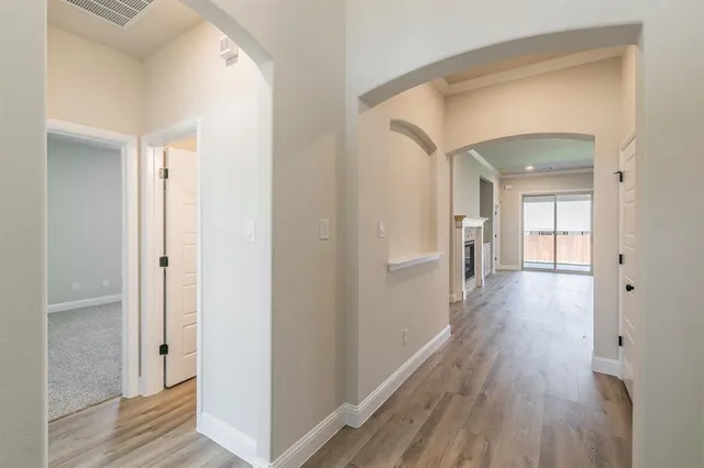 a view of a hallway with wooden floor