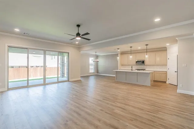 a view of a kitchen with a sink and wooden floor
