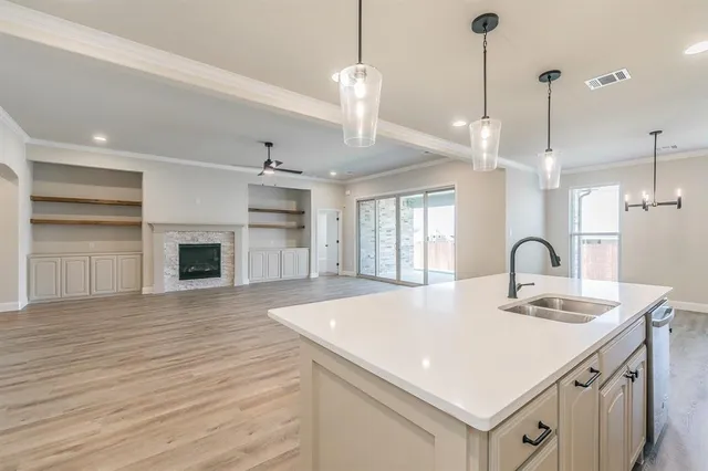 a kitchen with a sink a stove and kitchen island