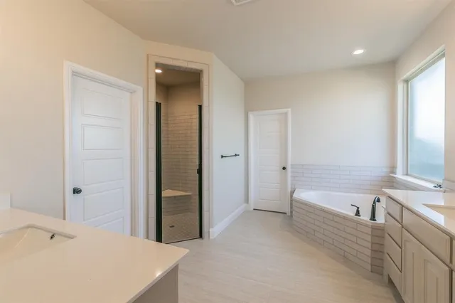a bathroom with a bathtub and a sink