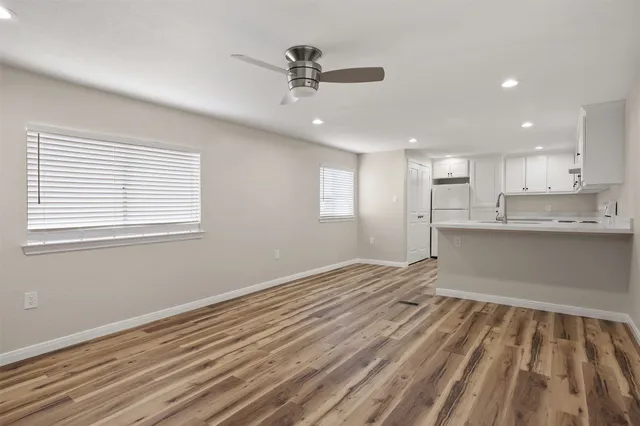 a view of an empty room with a kitchen