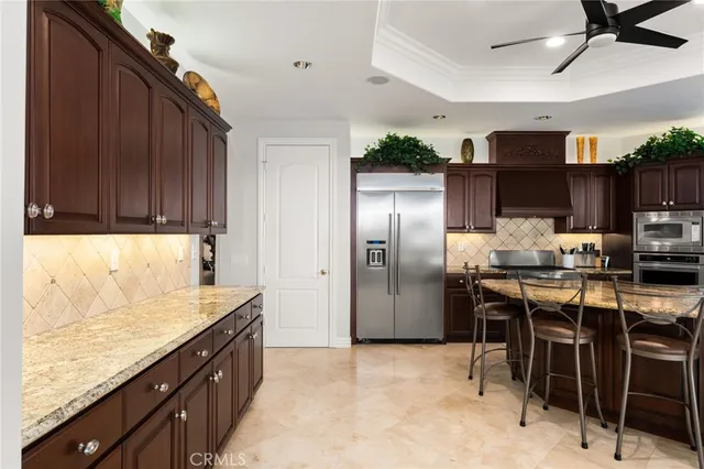 a kitchen with stainless steel appliances granite countertop a refrigerator stove top oven and sink