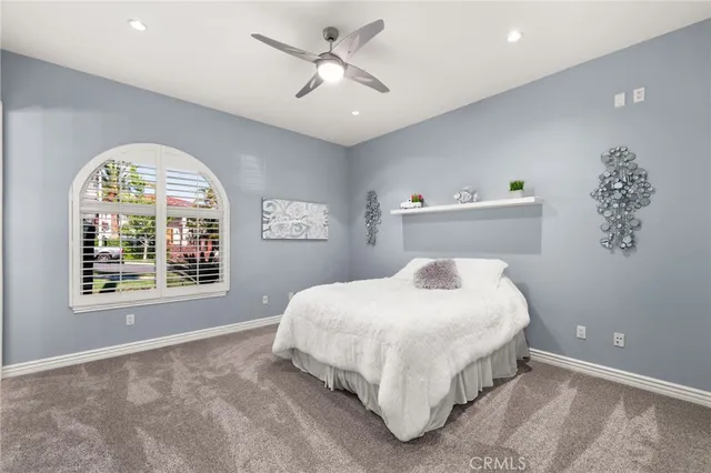 a bedroom with a large bed and a window