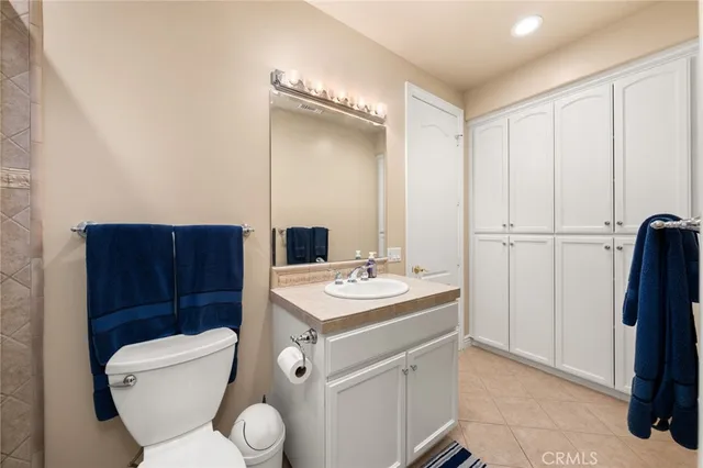 a bathroom with a toilet a sink and a mirror