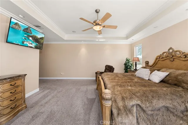 a bedroom with a bed and ceiling fan