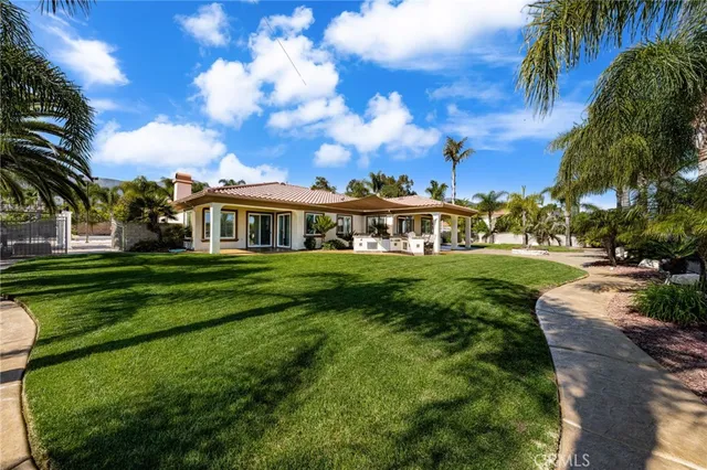 a view of an apartment with a big yard and potted plants
