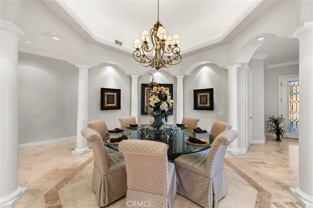a living room with fireplace furniture and a chandelier