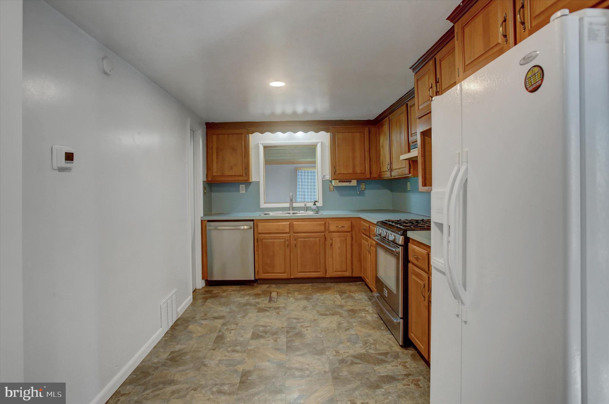 1611 Pine Road Carlisle, PA 17015 - Photo 9 of 45 a large white kitchen with a sink a stove and refrigerator