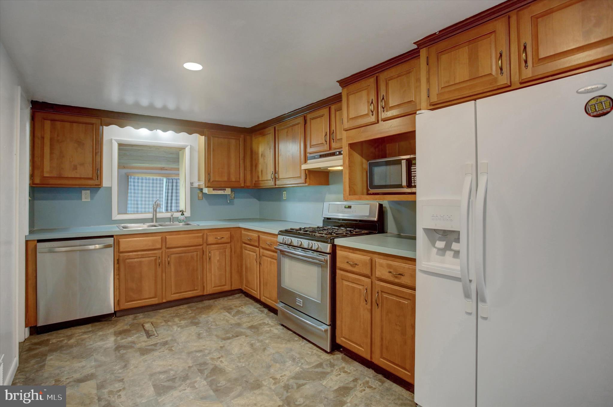 1611 Pine Road Carlisle, PA 17015 - Photo 10 of 45 a kitchen with stainless steel appliances granite countertop a stove a sink and a refrigerator
