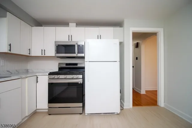 a kitchen with cabinets and white appliances