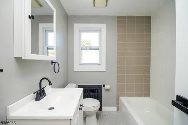 a bathroom with a sink a toilet and a bathtub