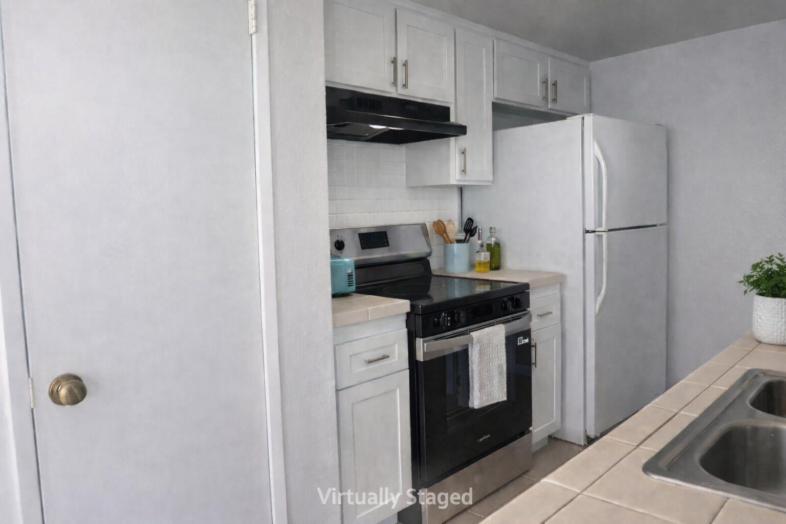 5935 Hickory Street, Unit 3 Carpinteria, CA 93013 - Photo 6 of 10 a kitchen with a refrigerator stove and cabinets