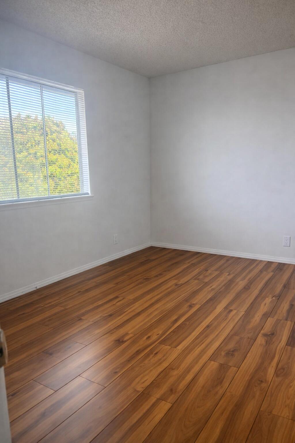 5935 Hickory Street, Unit 3 Carpinteria, CA 93013 - Photo 9 of 10 a view of an empty room with wooden floor and a window