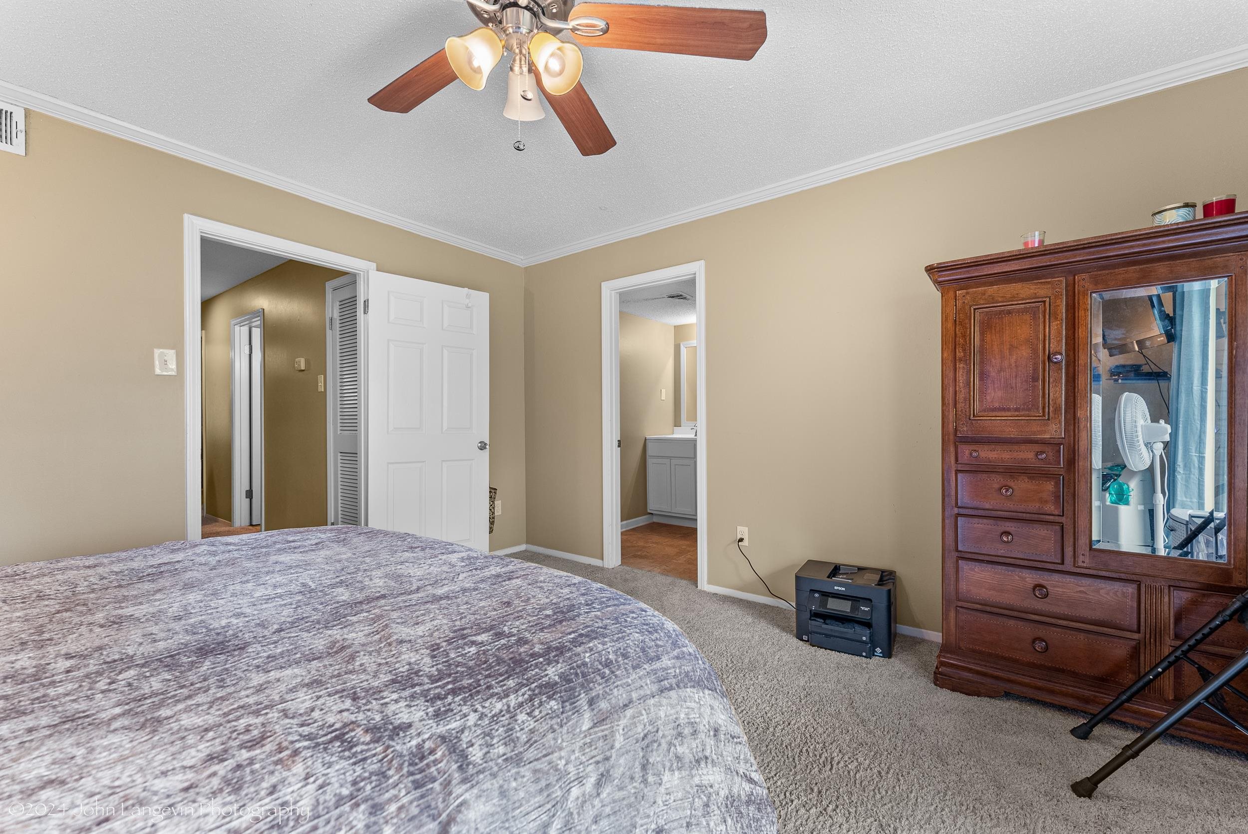 3118 Knob Hill Road Lakeland, TN 38002 - Photo 14 of 27 Carpeted bedroom with crown molding, ceiling fan, and ensuite bath