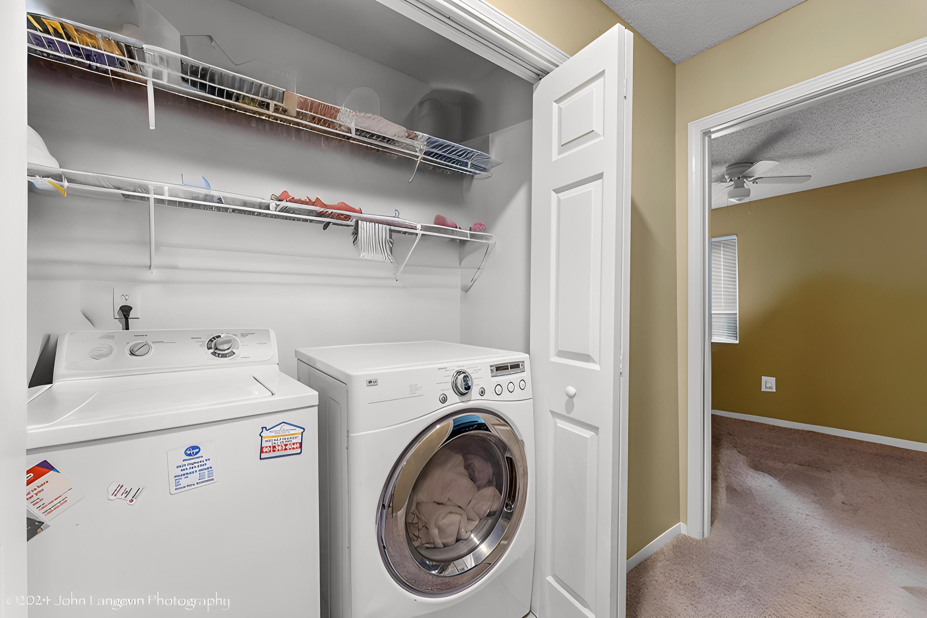 3118 Knob Hill Road Lakeland, TN 38002 - Photo 16 of 27 Laundry room featuring ceiling fan, washer and dryer, and carpet flooring