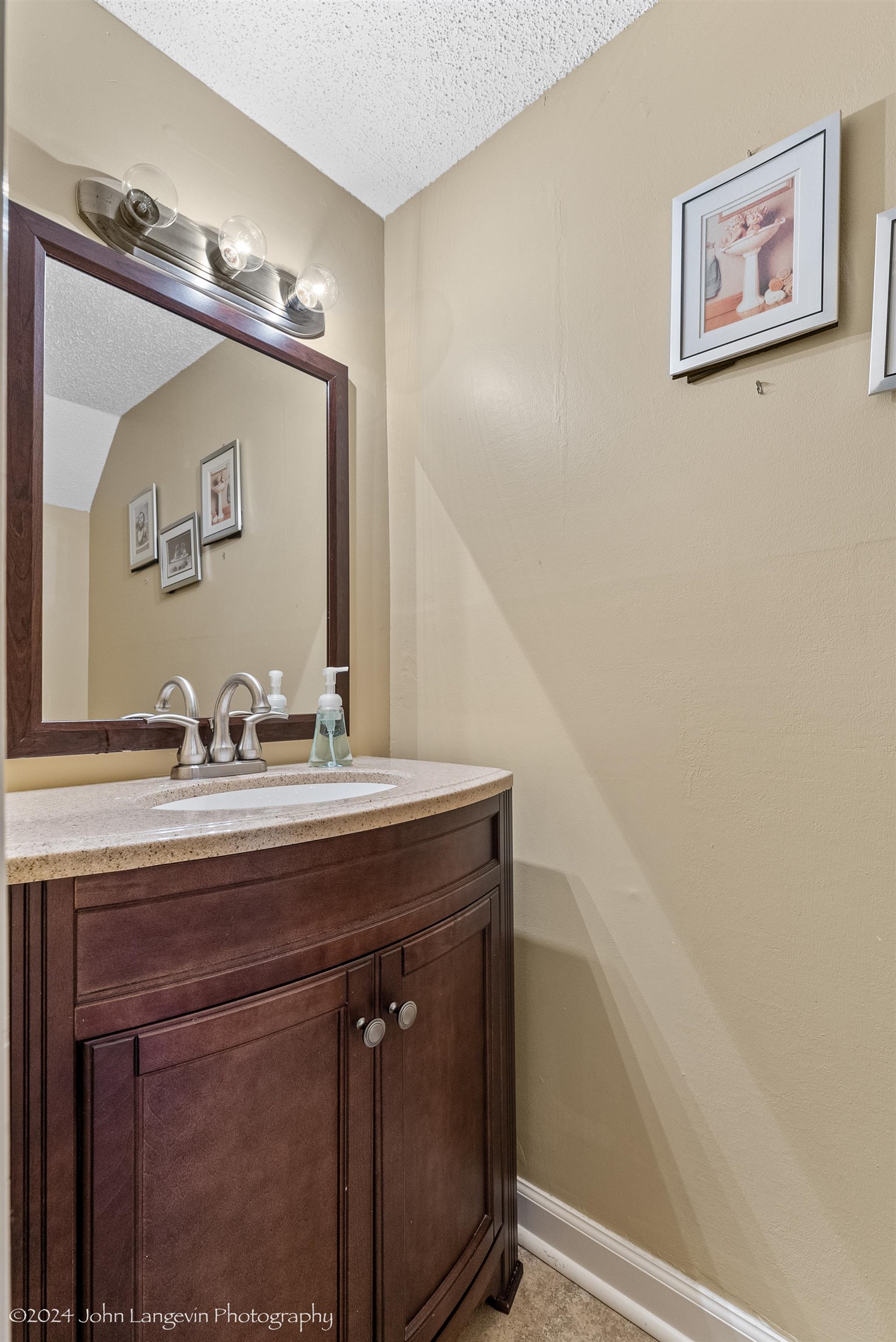 3118 Knob Hill Road Lakeland, TN 38002 - Photo 24 of 27 Bathroom featuring a textured ceiling, lofted ceiling, and vanity