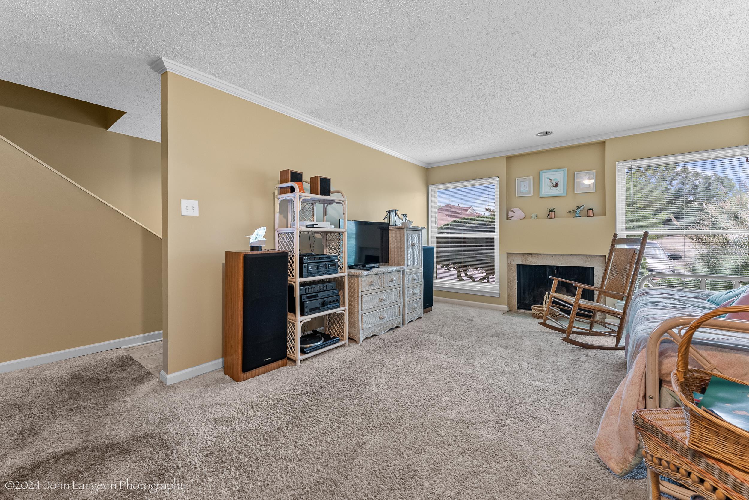 3118 Knob Hill Road Lakeland, TN 38002 - Photo 6 of 27 Carpeted living room featuring a textured ceiling, ornamental molding, and plenty of natural light