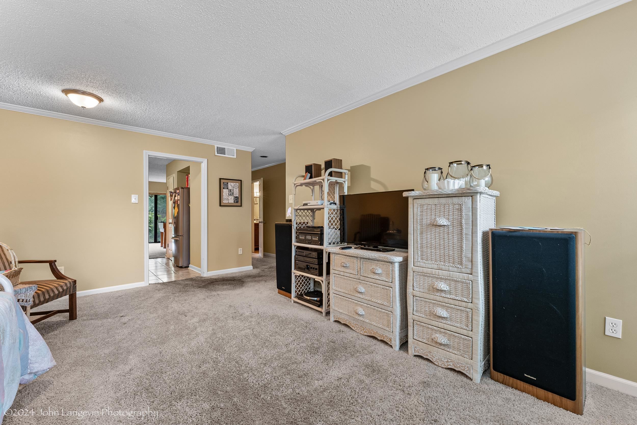 3118 Knob Hill Road Lakeland, TN 38002 - Photo 7 of 27 Interior space with ornamental molding, a textured ceiling, light carpet, and water heater