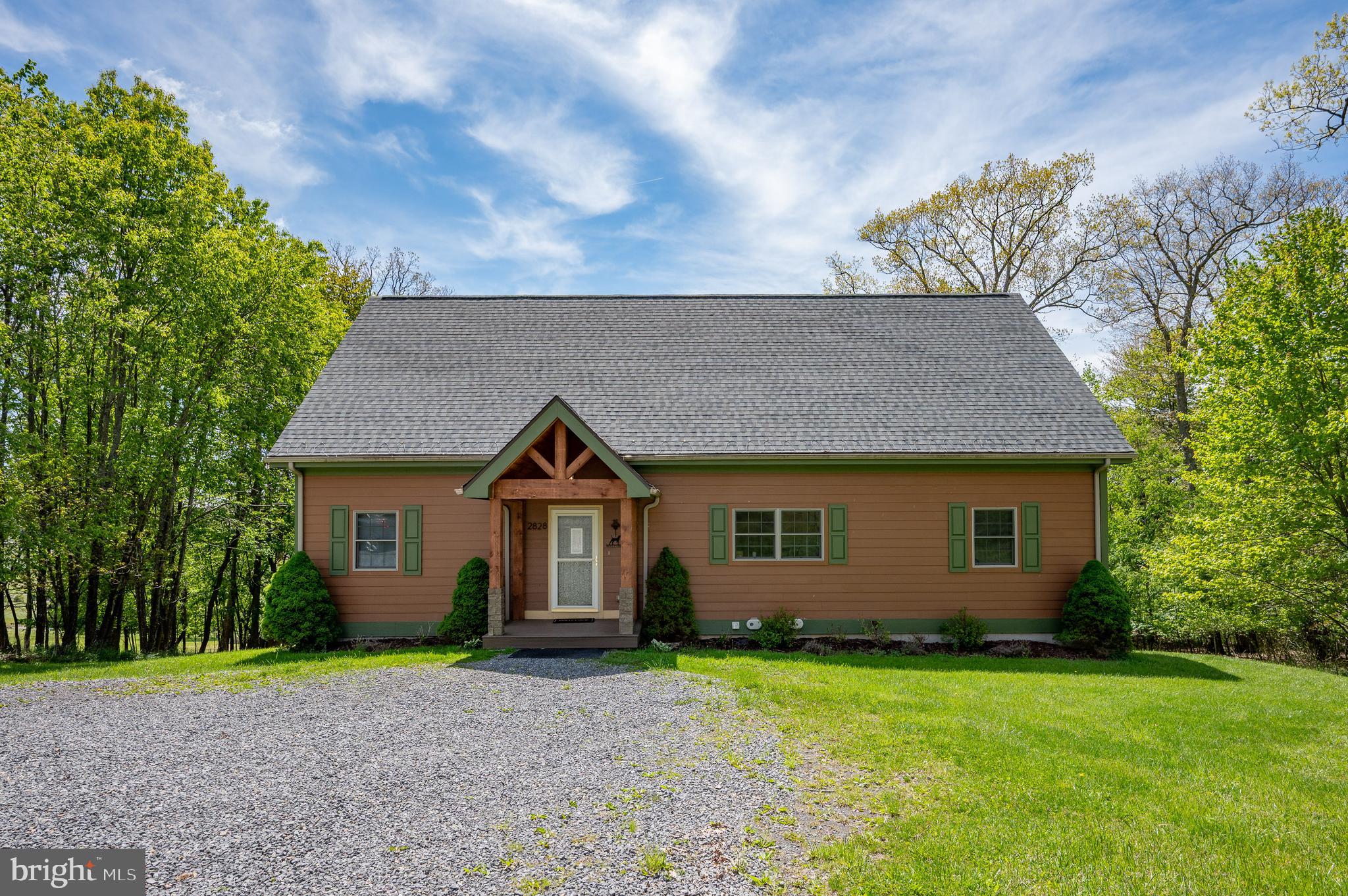 2828 Glendale Road Swanton, MD 21561 - Photo 49 of 78 a front view of a house with a yard and garage
