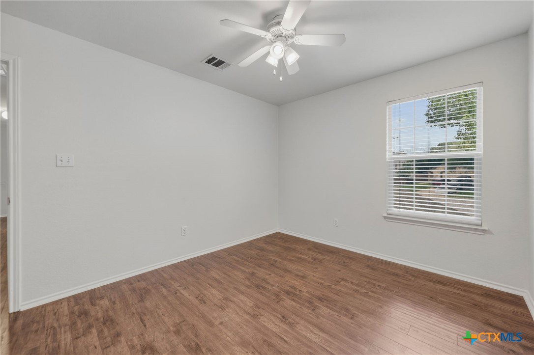 109 Comal Cove Elgin, TX 78621 - Photo 18 of 34 a view of a big room with wooden floor and a chandelier fan