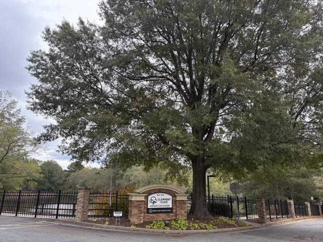 a sign board with large trees
