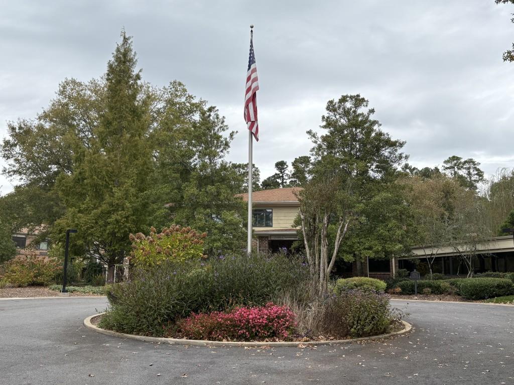 1800 Clairmont Lake, Unit 124 Decatur, GA 30033 - Photo 3 of 22 a front view of a house with a yard and tree s